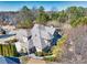 Aerial shot of home showcasing a spacious backyard, landscaping, and three car garage at 955 Golf View Ct, Dacula, GA 30019