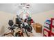 A cluttered attic space contains exercise equipment, storage containers, and natural light from a window at 955 Golf View Ct, Dacula, GA 30019