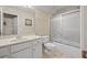 Bright bathroom featuring a white vanity with sink and a shower with framed sliding glass doors at 955 Golf View Ct, Dacula, GA 30019