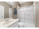 Bathroom features a shower-tub combo, glass door, single sink, and is well-lit at 955 Golf View Ct, Dacula, GA 30019