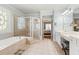 Bathroom featuring a jetted tub, separate shower, and double sink vanity at 955 Golf View Ct, Dacula, GA 30019