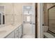 Bright bathroom features dual sinks, white cabinetry, a tile shower, and access to a large bedroom at 955 Golf View Ct, Dacula, GA 30019