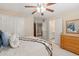 Bedroom with ensuite bathroom features carpet, ceiling fan, neutral paint, and white doors at 955 Golf View Ct, Dacula, GA 30019