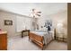 Cozy bedroom with neutral paint, ceiling fan, shutters, bedside tables and lamps at 955 Golf View Ct, Dacula, GA 30019