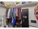 A closet includes shelving, hanging clothes, and a sentry safe for secure storage at 955 Golf View Ct, Dacula, GA 30019