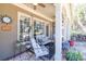 Inviting covered patio with stone flooring, ceiling fans, and comfortable seating with patterned pillows at 955 Golf View Ct, Dacula, GA 30019