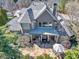 Aerial view of a home with stone patio, outdoor seating, and a well-manicured lawn at 955 Golf View Ct, Dacula, GA 30019
