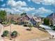 Beautifully landscaped home featuring lush greenery, mature trees, and a well-maintained lawn at 955 Golf View Ct, Dacula, GA 30019