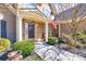 Charming front entrance with stone accents, a covered porch, seating, and manicured landscaping at 955 Golf View Ct, Dacula, GA 30019