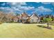 Beautiful home featuring a well-maintained lawn, mature trees, and manicured landscaping at 955 Golf View Ct, Dacula, GA 30019