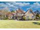 Charming two-story home with lush landscaping, a circular driveway, and classic architectural details at 955 Golf View Ct, Dacula, GA 30019