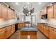 Well-lit kitchen with granite countertops, wooden cabinets, and a central island at 955 Golf View Ct, Dacula, GA 30019