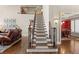 Elegant staircase next to a living room and a dining room at 955 Golf View Ct, Dacula, GA 30019