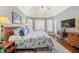 Spacious main bedroom featuring tray ceilings, hardwood floors, sitting area, and large windows at 955 Golf View Ct, Dacula, GA 30019
