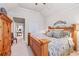 The main bedroom includes a wooden king-size bed, armoire, and doorway that leads to an office space at 955 Golf View Ct, Dacula, GA 30019