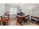 A home office with a wood desk, hardwood floors, and natural light from the window at 955 Golf View Ct, Dacula, GA 30019