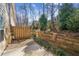 Serene backyard with a retaining wall and a small patio area at 2075 Pine Tree Dr # D4, Buford, GA 30518
