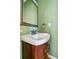 Cozy bathroom featuring a stylish sink with a wooden cabinet and an ornate mirror at 2075 Pine Tree Dr # D4, Buford, GA 30518