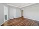 Spacious bedroom with hardwood floors, neutral paint, tray ceiling, and two closets providing ample storage at 2075 Pine Tree Dr # D4, Buford, GA 30518