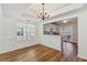 Dining room and view of kitchen with hardwood floors and stylish chandelier at 2075 Pine Tree Dr # D4, Buford, GA 30518