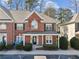 Charming brick townhome with a covered porch and well-maintained landscaping at 2075 Pine Tree Dr # D4, Buford, GA 30518