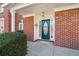 Close up of the front door and porch with brick facade at 2075 Pine Tree Dr # D4, Buford, GA 30518