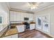 Well-lit kitchen features granite counters, stainless appliances, and access to outdoors at 2075 Pine Tree Dr # D4, Buford, GA 30518