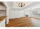 Hardwood floor view of the living room, kitchen, and fireplace at 2075 Pine Tree Dr # D4, Buford, GA 30518