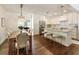 Open-concept kitchen and dining area features wood floors, white cabinets, and stainless steel appliances at 2083 Golfview Dr, Atlanta, GA 30309