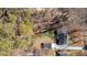 Aerial view of the home showing the roof, driveway, and surrounding trees at 5079 N Dogwood Hills Dr, Buford, GA 30518