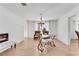 Bright dining room with modern light fixture and glass table at 5079 N Dogwood Hills Dr, Buford, GA 30518