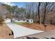 This property includes a long driveway leading up to a charming single-story home with a detached garage at 5079 N Dogwood Hills Dr, Buford, GA 30518