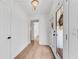 Hallway showcasing hardwood floors, a decorative light fixture, and a view to the outside at 5079 N Dogwood Hills Dr, Buford, GA 30518