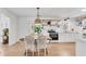 Bright kitchen open to dining area, with white cabinets and countertops, and stainless steel appliances at 5079 N Dogwood Hills Dr, Buford, GA 30518