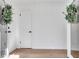 Bright foyer with wood floors, white trim, and a view of the front entrance at 5079 Ne Dogwood Hills Dr, Sugar Hill, GA 30518