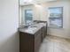 Elegant bathroom featuring double sinks, granite countertops, and ample natural light at 807 Ambient Sw Way, Atlanta, GA 30331