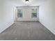 Bright bedroom with two windows and neutral walls and floors at 807 Ambient Sw Way, Atlanta, GA 30331