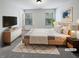 Tranquil, virtually staged bedroom with a comfy bed, neutral tones, and lots of light at 807 Ambient Sw Way, Atlanta, GA 30331
