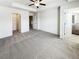 Comfortable bedroom with neutral carpeting, tray ceiling, and walk-in closet at 807 Ambient Sw Way, Atlanta, GA 30331