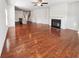 Expansive living area with hardwood floors, fireplace, and an open layout to the kitchen and staircase at 807 Ambient Sw Way, Atlanta, GA 30331