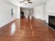 Bright open-concept living room with hardwood floors, fireplace and views into the kitchen at 807 Ambient Sw Way, Atlanta, GA 30331