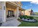 Inviting front porch with ornate front door, decorative columns, exterior seating and manicured landscaping at 1118 Reddy Farm Rd, Grayson, GA 30017