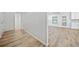 Hallway view that leads to the kitchen and features neutral walls and wood flooring at 1118 Reddy Farm Rd, Grayson, GA 30017