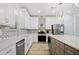 Well-lit kitchen featuring modern appliances, gray island, and patterned backsplash at 1118 Reddy Farm Rd, Grayson, GA 30017