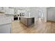 Modern kitchen with stainless steel appliances and a large gray island with a wine rack at 1118 Reddy Farm Rd, Grayson, GA 30017