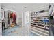 Walk-in closet with custom shelving and shoe racks leading to bathroom at 1118 Reddy Farm Rd, Grayson, GA 30017