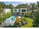 Stunning aerial view of a modern home with a pool, manicured landscaping, and lush greenery at 1260 Brook Forest Ne Dr, Atlanta, GA 30324