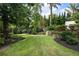 Lush backyard featuring a well-manicured lawn, mature trees, and manicured landscaping at 1260 Brook Forest Ne Dr, Atlanta, GA 30324