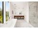 Elegant bathroom with soaking tub, glass shower, and marble tile at 1260 Brook Forest Ne Dr, Atlanta, GA 30324