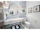 Stylish bathroom with a marble countertop, patterned wallpaper, and modern fixtures at 1260 Brook Forest Ne Dr, Atlanta, GA 30324
